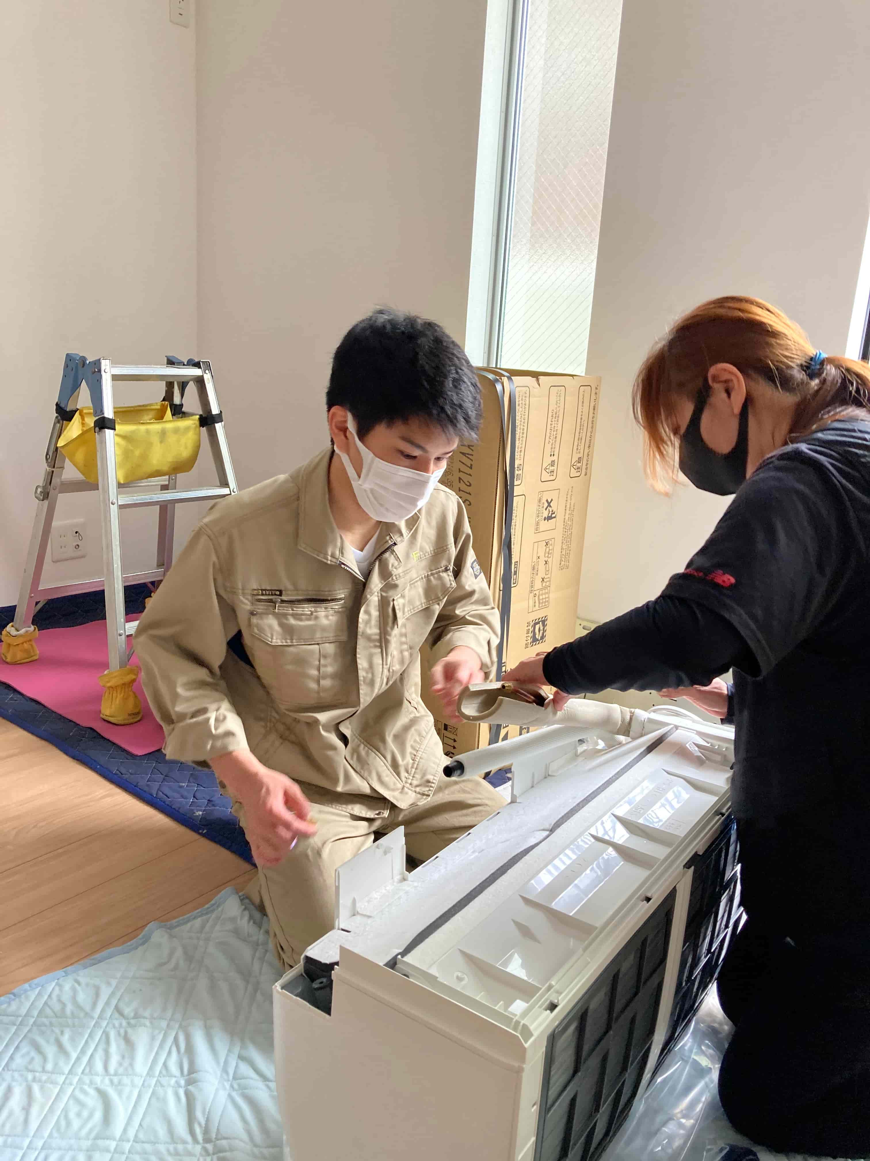 先輩のレクチャーを受けながら部材を準備する様子